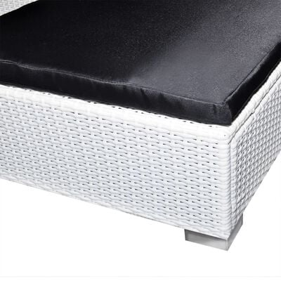 Close-up of white wicker furniture frame showing woven texture and cushion edge