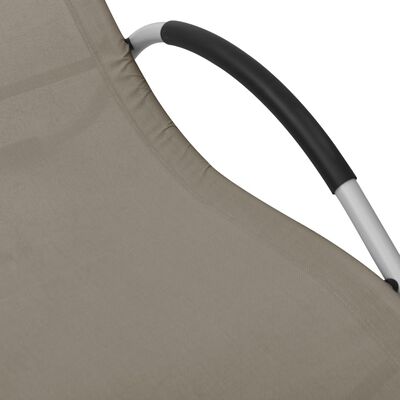 Close-up of the curved black armrest cover and beige frame of the chaise lounge.