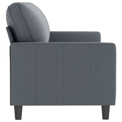 Side view of a grey armrested sofa showing arm, back and leg, with visible stitching