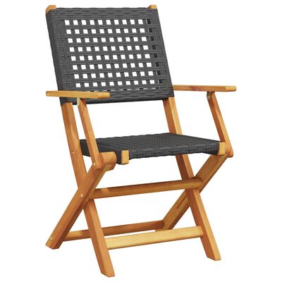 Close-up of a grey woven outdoor chair with wooden arms and X-frame legs.