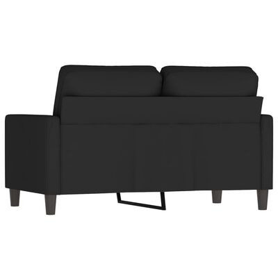Back view of black sofa with chaise-like extended section and visible metal leg support