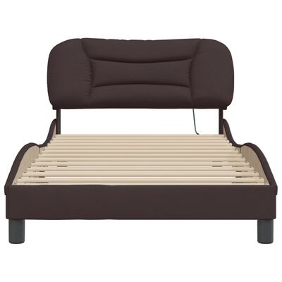 Front view of brown upholstered bed frame showing slat system and padded headboard.