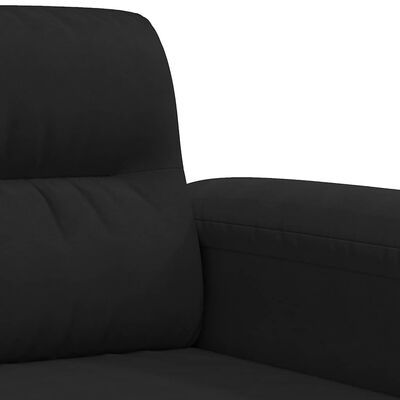 Close-up of the seam/armrest and cushions of the black sofa