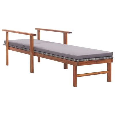 Wooden chaise lounge with gray cushions and armrails, side view