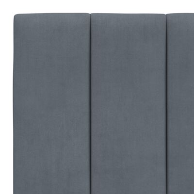 Vertical panels of the blue upholstered headboard showing multiple cushions.