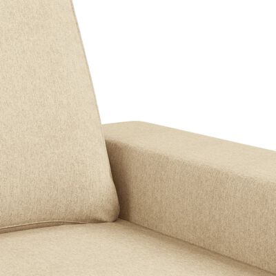 Close-up of sofa arm and seam, showing beige upholstery fabric texture.