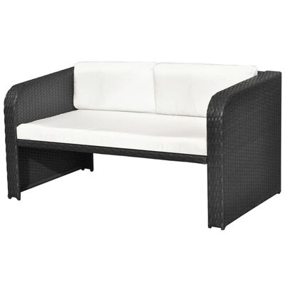 Close-up of dark wicker outdoor sofa showing white cushions.