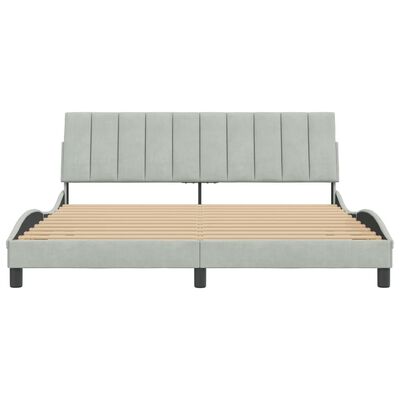 Front view of fully assembled bed with headboard and slatted base in light gray upholstery.