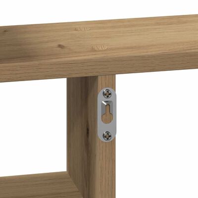 Close-up of metal mounting plate with screws on wooden shelf.