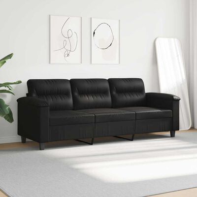 Black three-seat sofa in a minimalist room with white wall and a decorative mirror