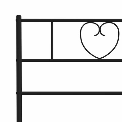Close-up of the headboard corner showing a decorative heart-shaped motif in the metal frame.