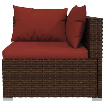 Wicker storage ottoman with red cushions on top.