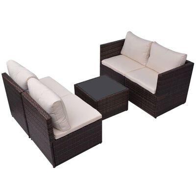 Two-seater sofa and armchair in brown wicker with beige cushions and a central glass-topped coffee table
