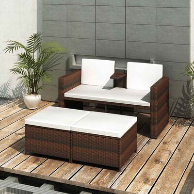 Outdoor wicker furniture set on wooden deck including two-seat sofa with white cushions and a rectangular coffee table with white cushions