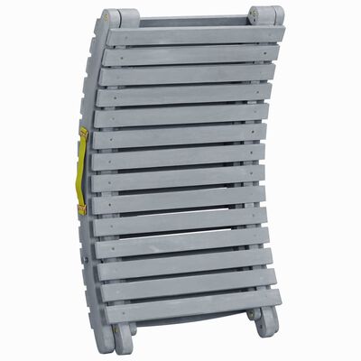 Close-up of grey slatted body of outdoor lounge chair with yellow adjustment strap