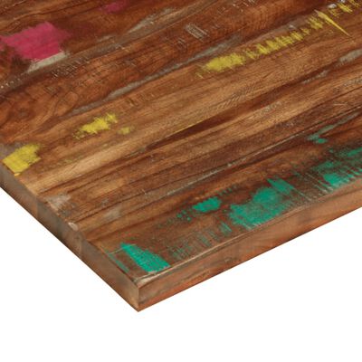 Close-up of painted wood surface showing turquoise and yellow paint marks