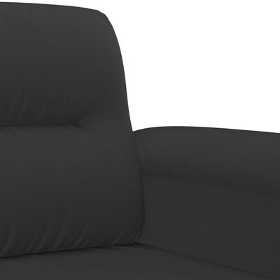 Close-up of the upholstery fabric on the armrest of the black sofa