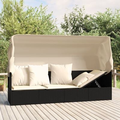 A large sectional outdoor sofa with beige cushions and a beige canopy on a wooden deck.