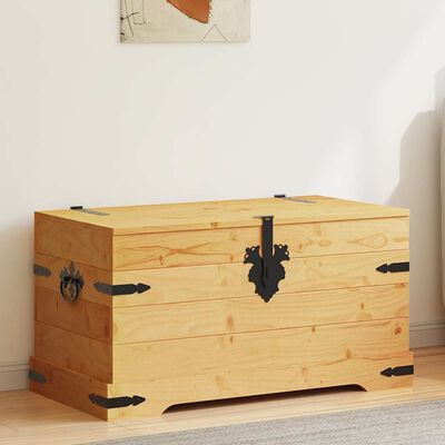 A light wood storage chest with black metal hinges and a decorative latch, placed on a wooden floor against a wall.