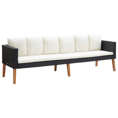 Three-seater dark woven outdoor sofa with white cushions and wooden legs.
