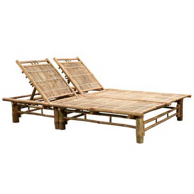 Two bamboo lounge chairs on a platform base.