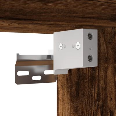 Close-up of metal mounting bracket attached to a wood cabinet.