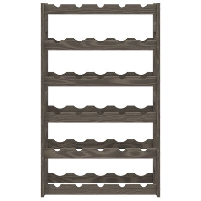 A close-up of a gray wooden wine rack showing multiple rows of bottle slots.