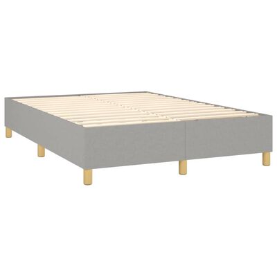 Grey platform bed frame without a mattress showing slatted bed base and light wood legs