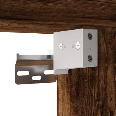 Close-up of metal bracket and connector attached to a rustic wood cabinet corner