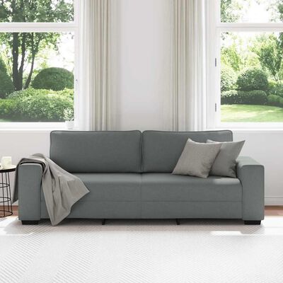 Grey fabric sofa with two back cushions in a bright room.