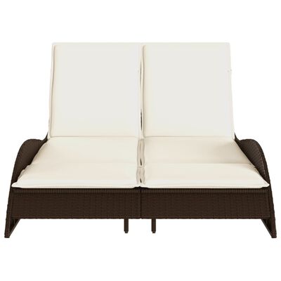 Front view of a brown wicker sofa chaise with two cream cushions