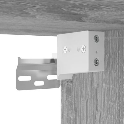 Close-up of metal bracket mounting plate attaching to wood cabinet.