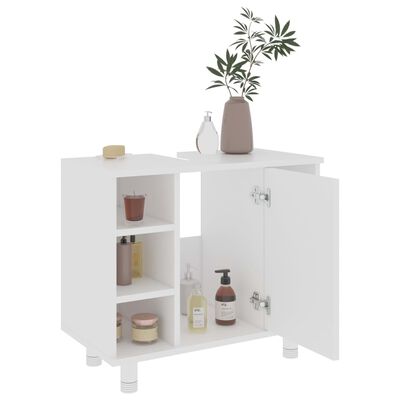 White bathroom cabinet with two small upper shelves and lower shelves and decor items on top.