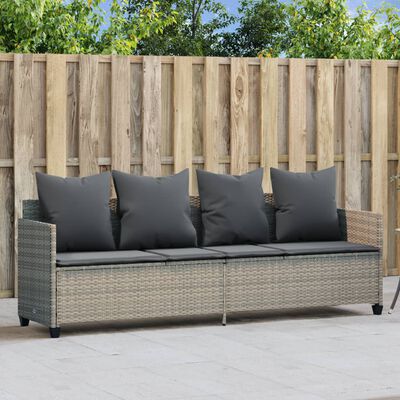 Outdoor sectional sofa with gray cushions and a wood-textured wicker base in a patio setting.