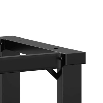 Close-up of top corner joint of black metal frame with screws.