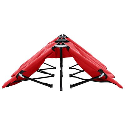 Side view of red folded canopy-like table with support bars