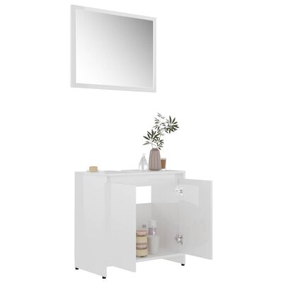 White bathroom cabinet with doors, small shelf on top with decor and mirror above.