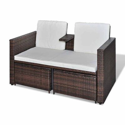 Outdoor brown wicker loveseat with two white back cushions and a center armrest with cup holder/panel; two wicker storage drawers below