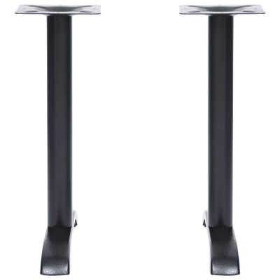 Two black legs with metal feet, side view.