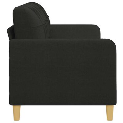Close-up side view of a black fabric sofa showing armrest and wooden leg.