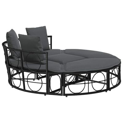 Round outdoor sofa with dark gray cushions and backrest pillow on left