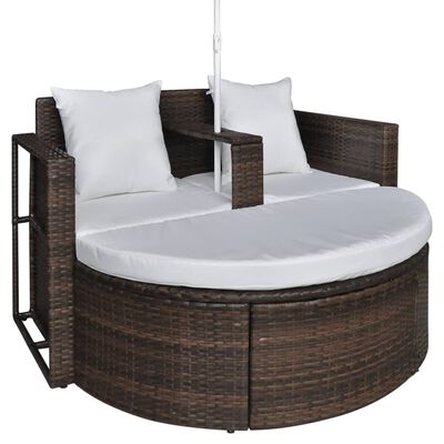 Close-up of a round wicker outdoor sofa base with white cushions and two front cushions.