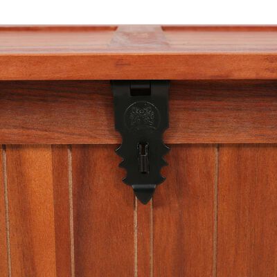 Close-up of black metal latch on wood chest.