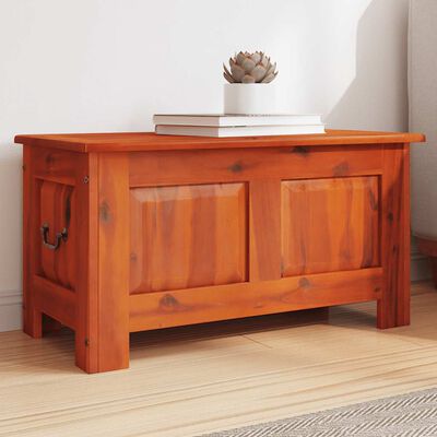 Wooden storage chest/bench in a living room setting with two side handles.
