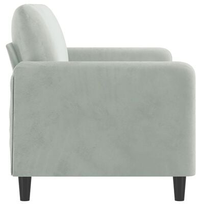 Side view of light gray/blue upholstered armchair-like sofa corner showing armrest and rounded edge.