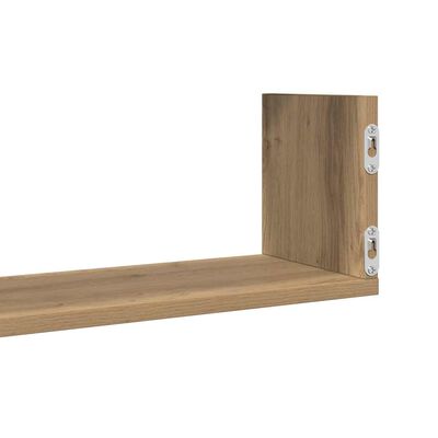 Close-up of one end of a wooden shelf with metal mounting brackets attached to the side.