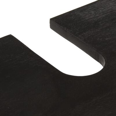 Close-up of a black wooden surface with curved cutout detail.