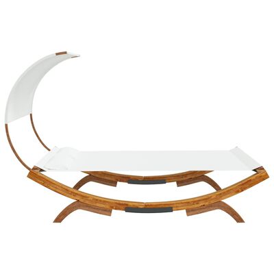 Side angled view of a white canopy daybed with curved wooden frame and extended chaise.