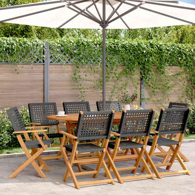 Outdoor dining set with eight wooden director chairs and a large white patio umbrella