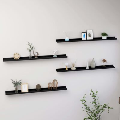 Set of five black wall shelves with decorative items on them mounted on a wall